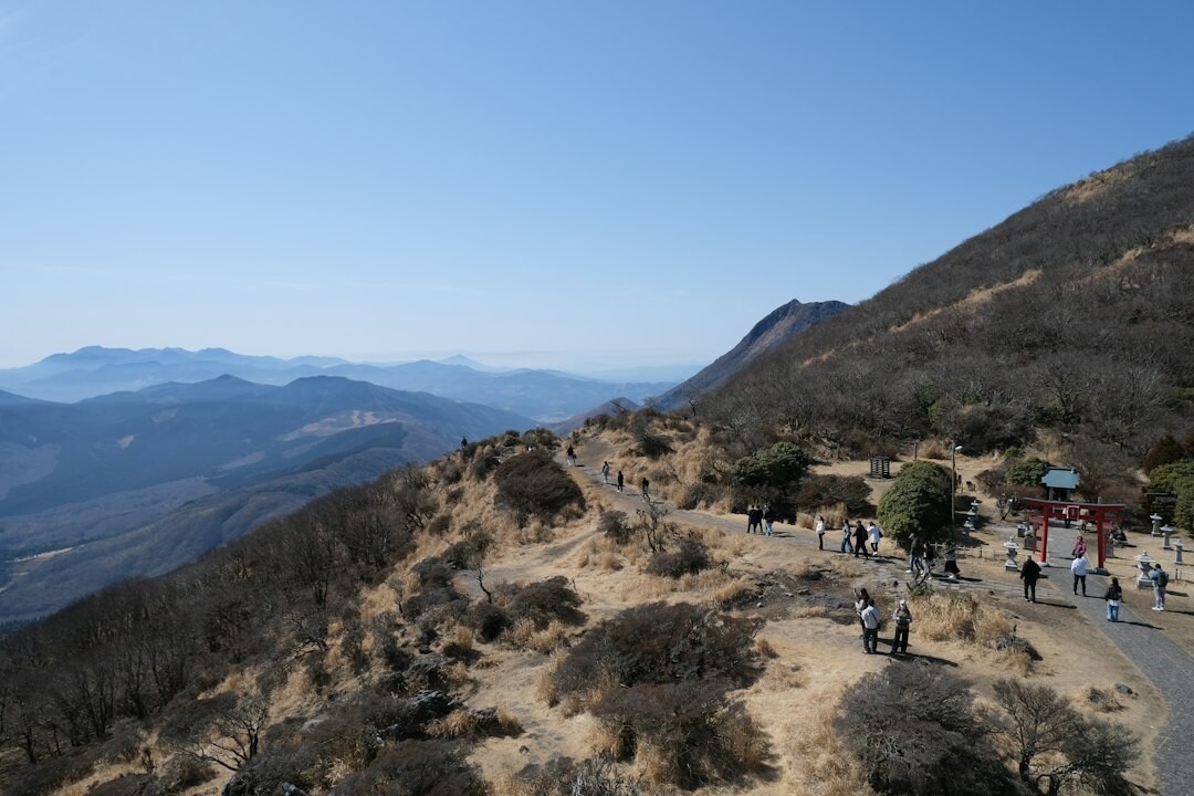 Group of elderly Japanese people hiking together on a mountain trail in autumn
