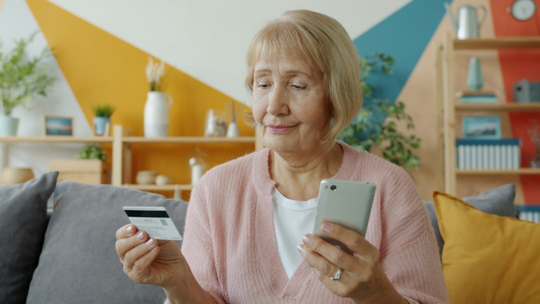 senior holding smartphone