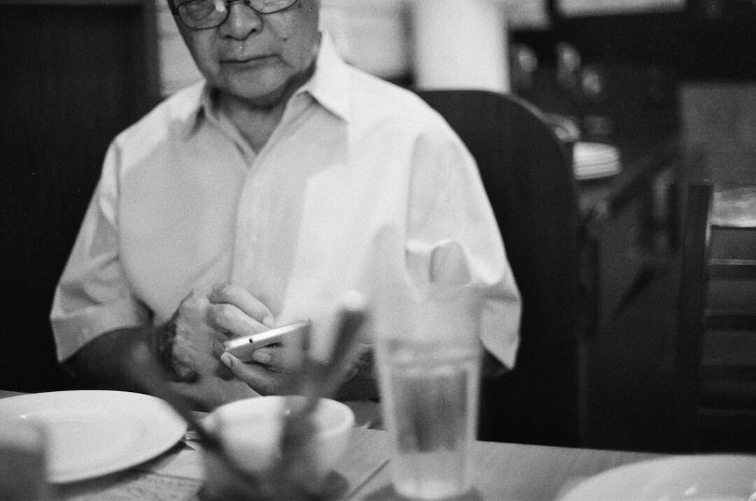 senior reading news on phone