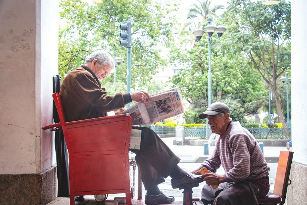 elderly couple reading newspaper