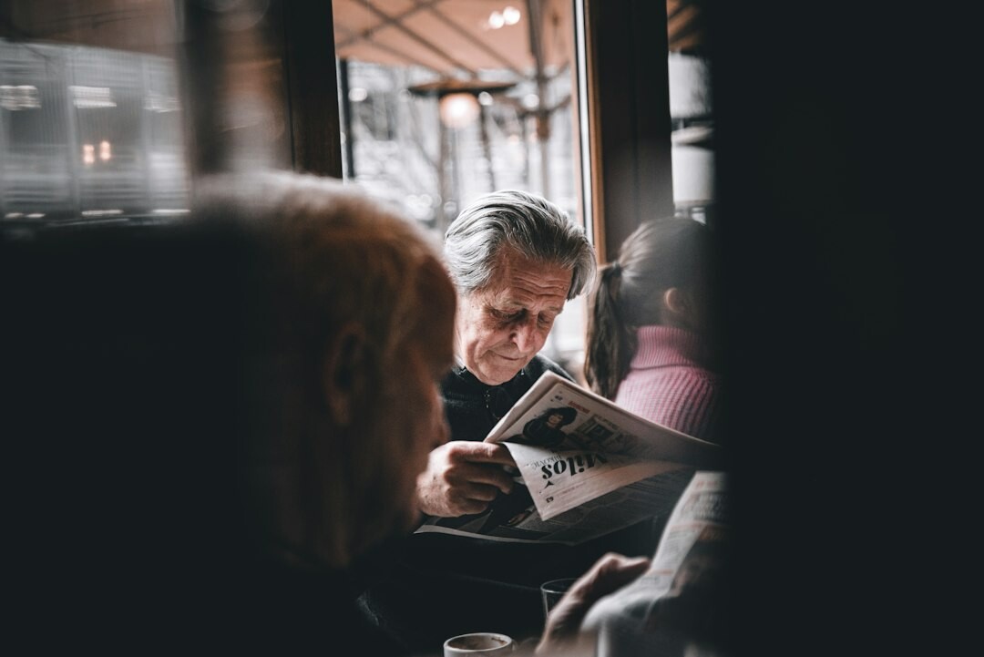 elderly couple reading newspaper