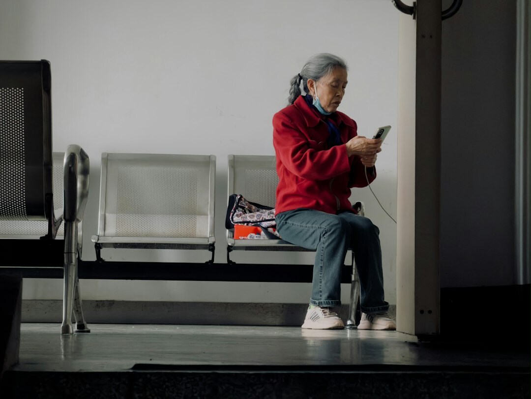 Elderly Japanese woman learning to use a tablet computer at home
